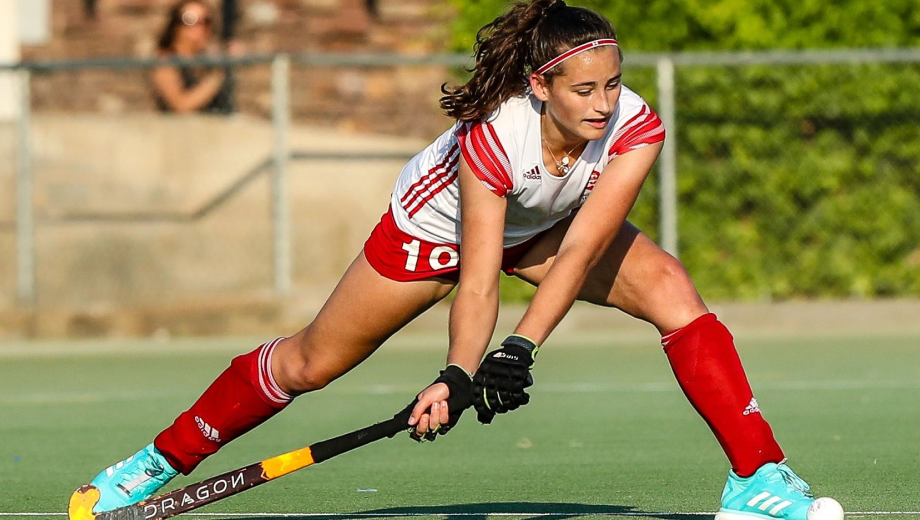 Female hockey player getting ready to strike the ball