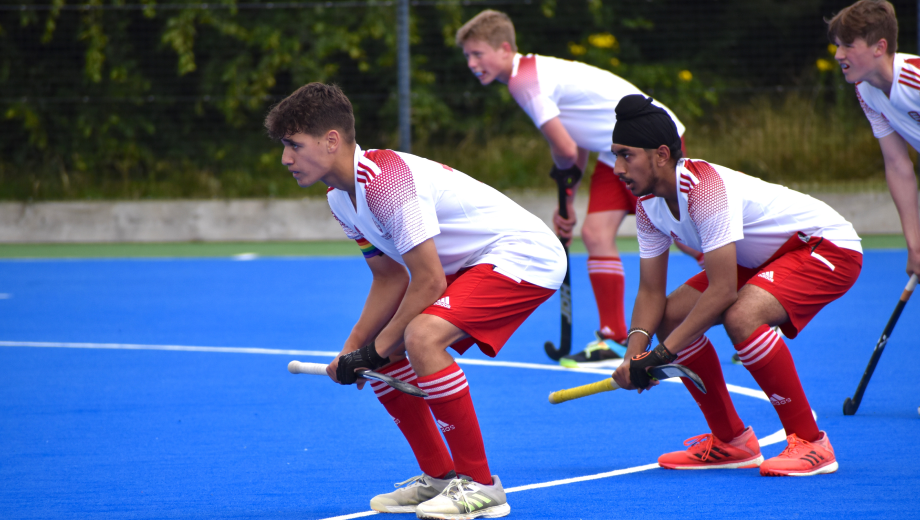 Male hockey player about to strike the ball