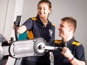 Sports student testing a piece of sporting equipment and recording data