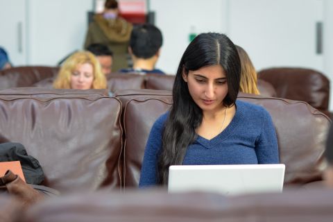 Employers sitting at desk with employees looking at a computer screen