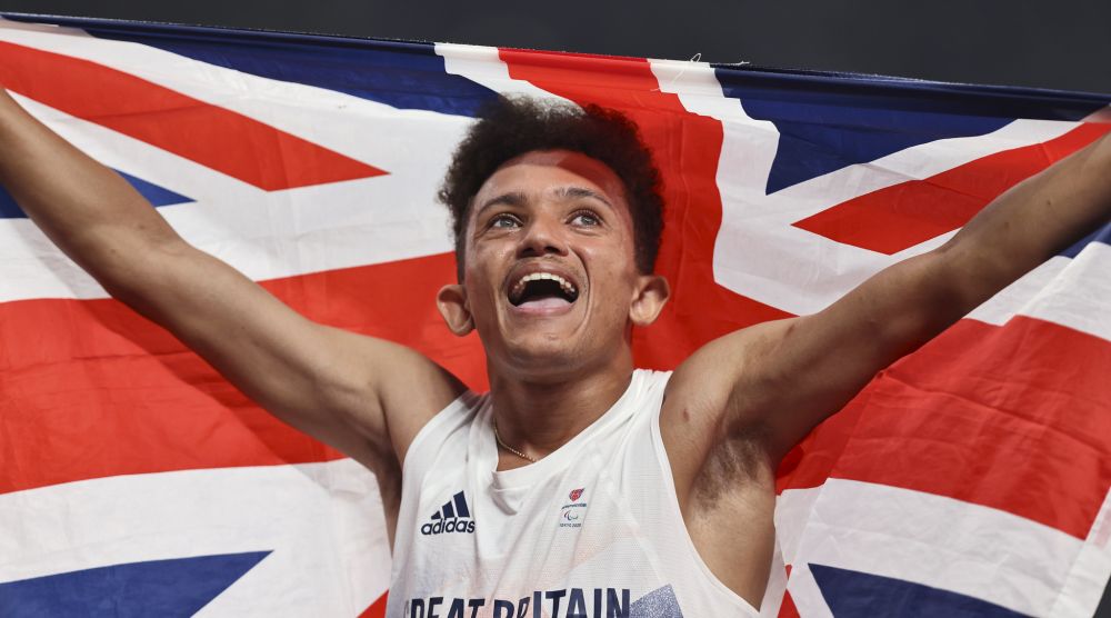 Thomas Young celebrating with a holding a union flag above his head