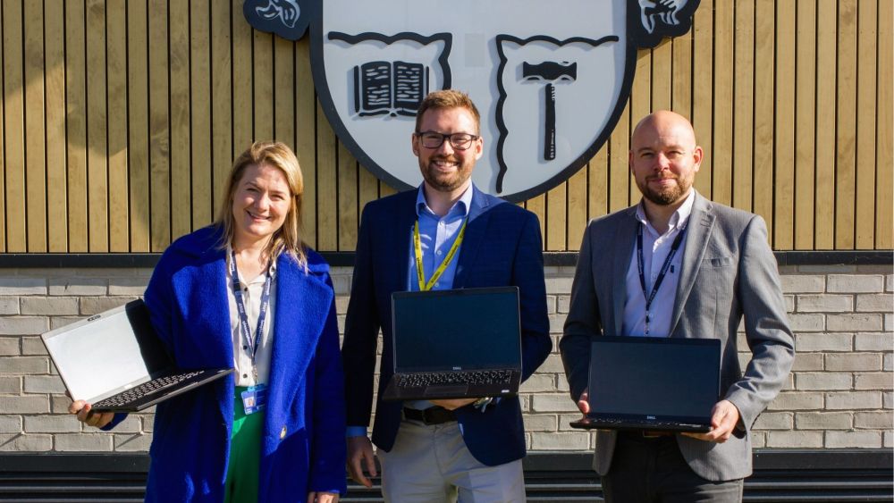 (L-R) Laura Shepherd, Sam Williams, and Chris Manton show some of the laptops that have been donated to Loughborough College