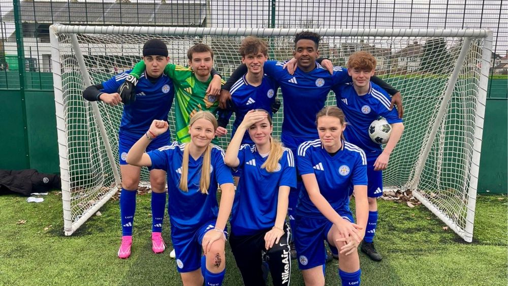 The Pan ability football team pose in front of a goal